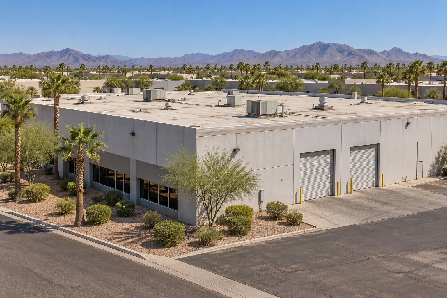 Light-manufacturing building with a large low-slope roof and loading doors